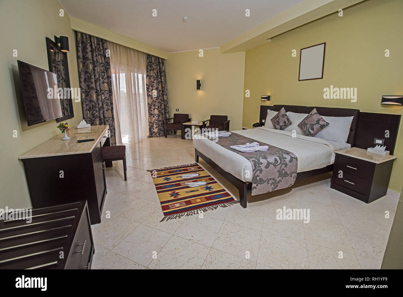 Double Bed In Suite Of A Luxury Hotel Room With Patio Door And