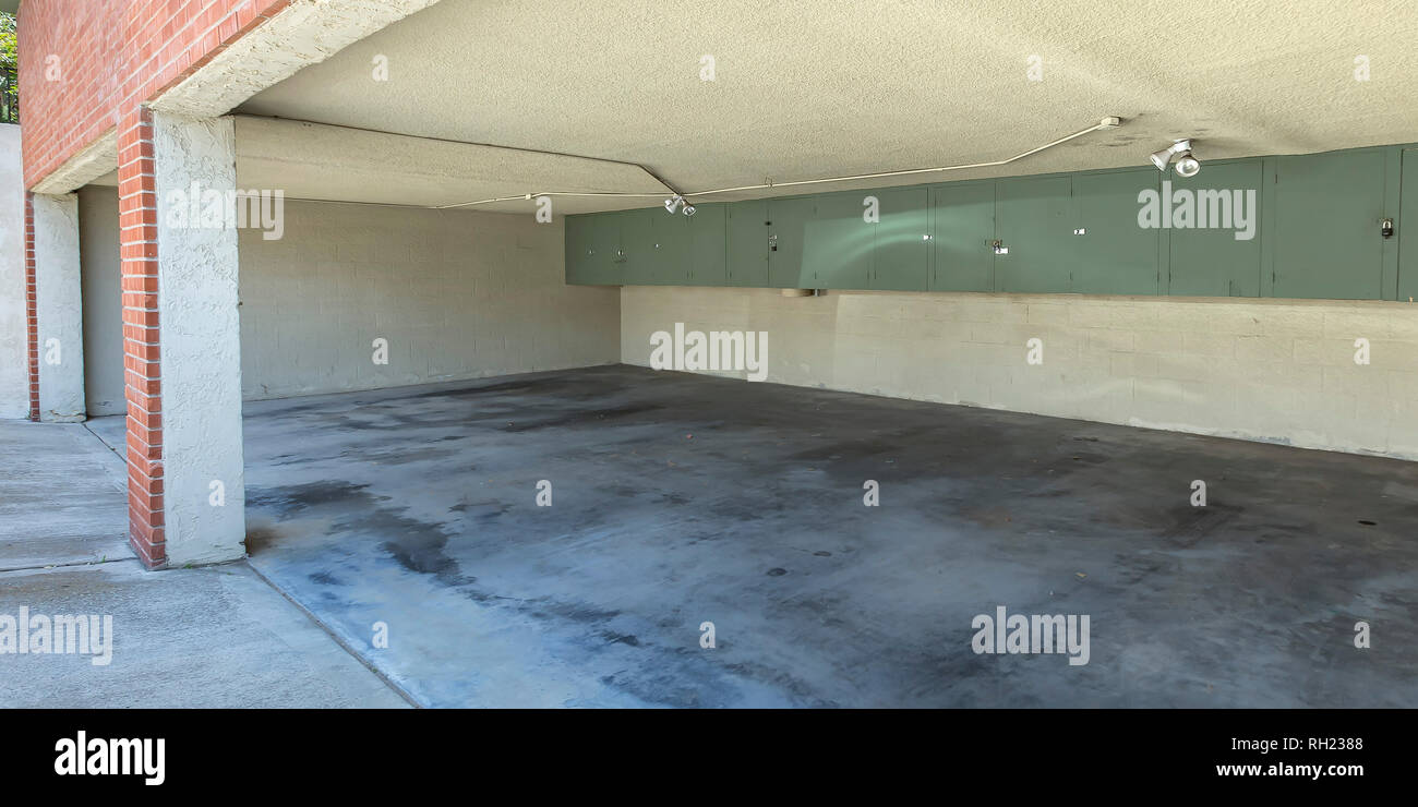Open Garage Of A Brick Building With Wall Cabinets Stock Photo