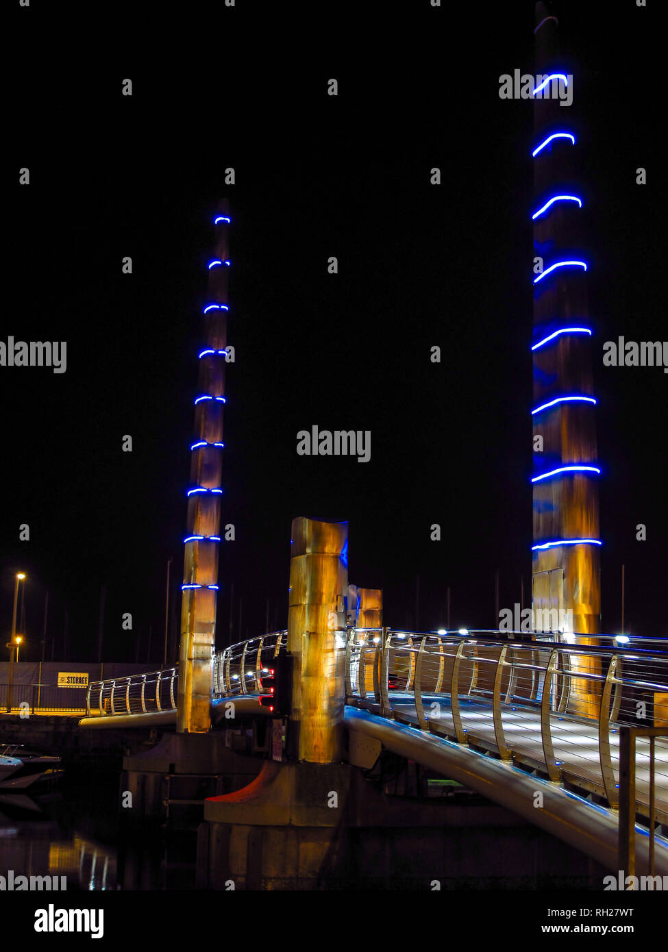 Torquay Marina Harbour Bridge, with blue and golden lights. Bridge rises to allow vessels in the marina. Stock Photo
