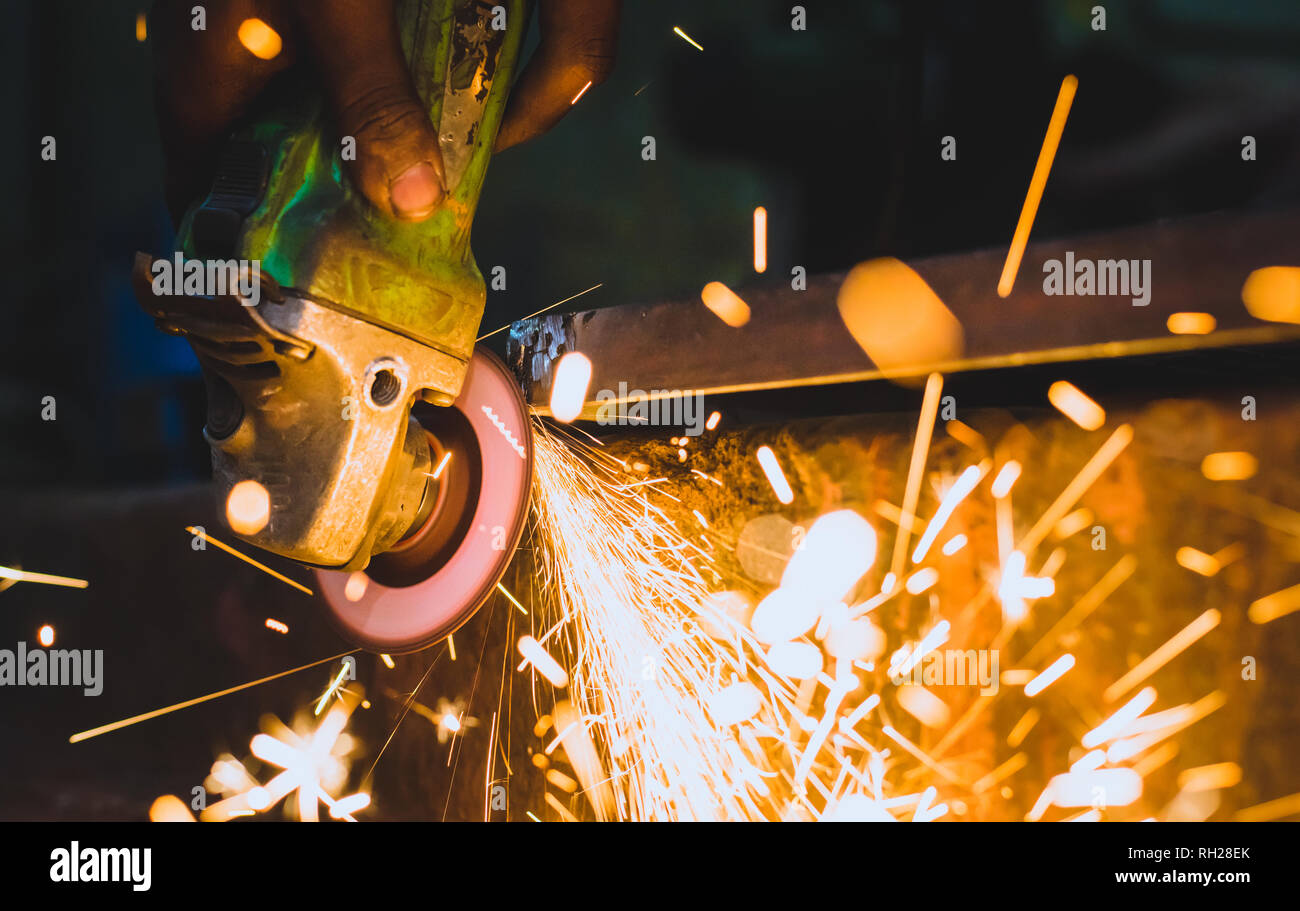 Worker using a grinder on a metal Stock Photo