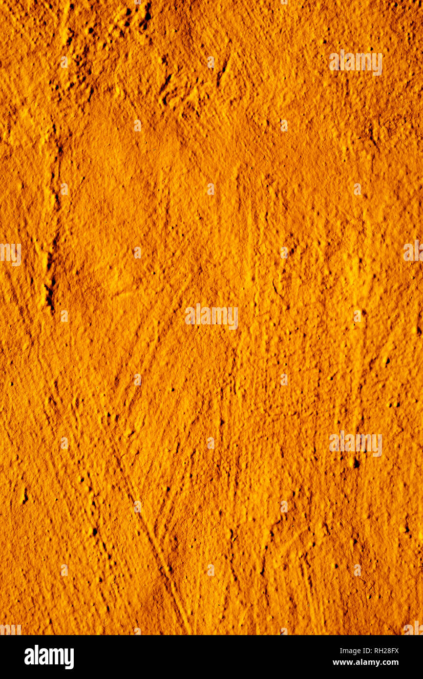 closeup of a rustic orange plastered wall to be used as a background Stock Photo