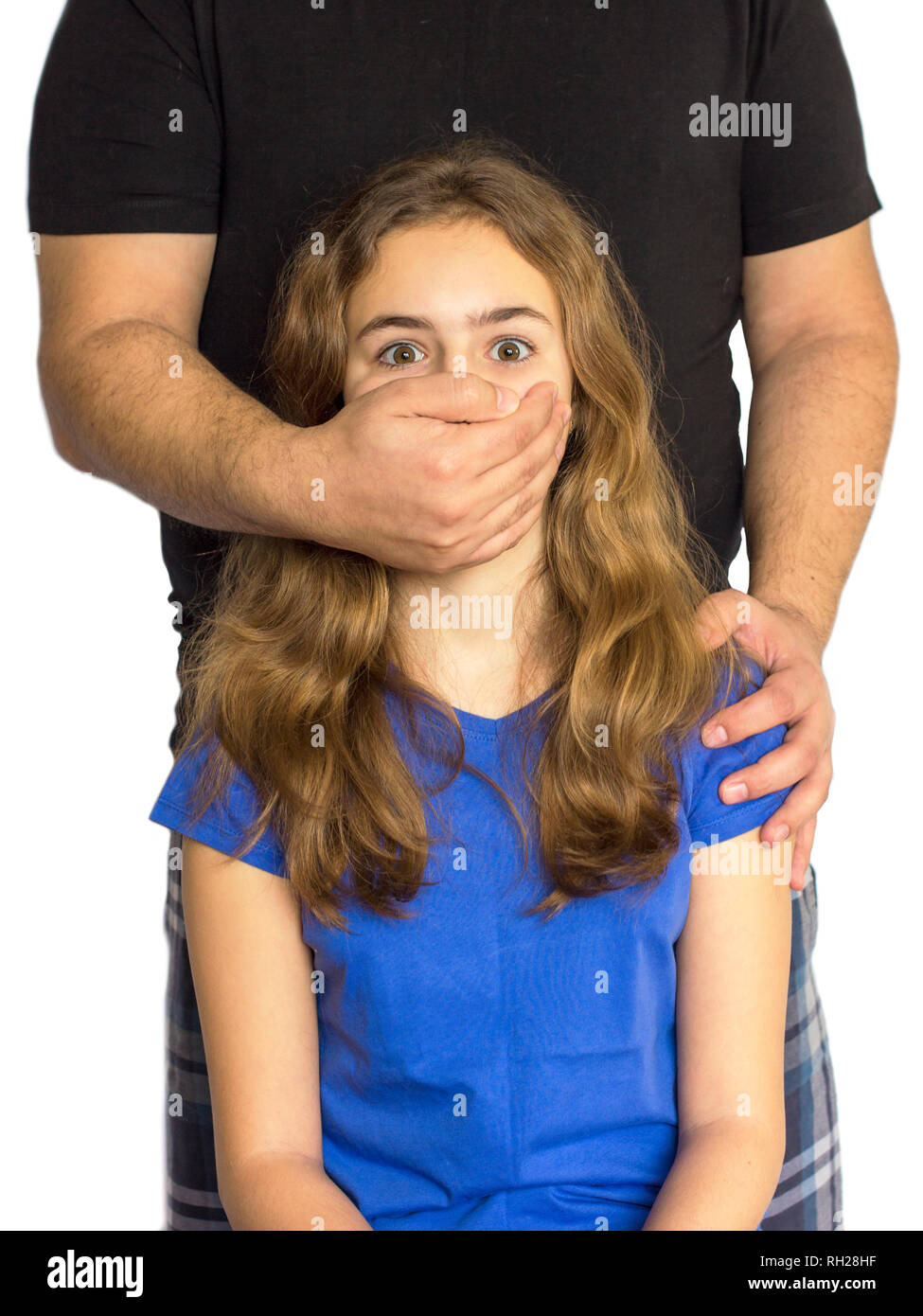 Child abuse, violence in family. Man shuts girl mouth with his hand Stock Photo