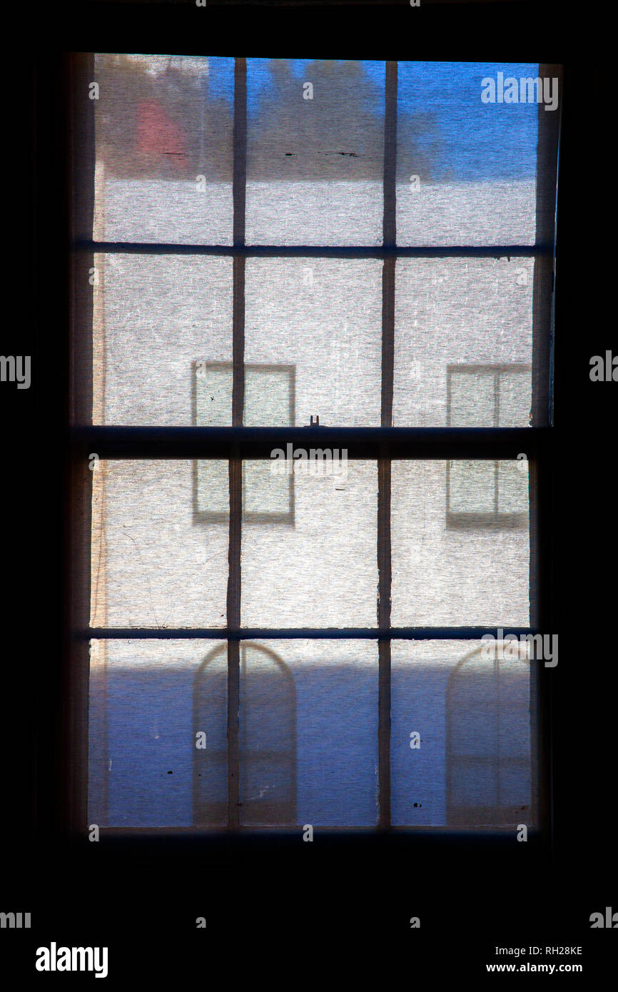 windows and house frontage seen through window blind Stock Photo