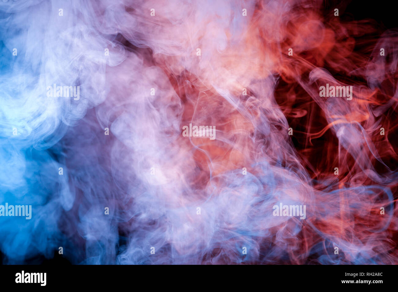The beautiful color combination of blue, orange, violet and red hues from  the substance is smoke, on a black background resembling the Milky Way.  T-sh Stock Photo - Alamy
