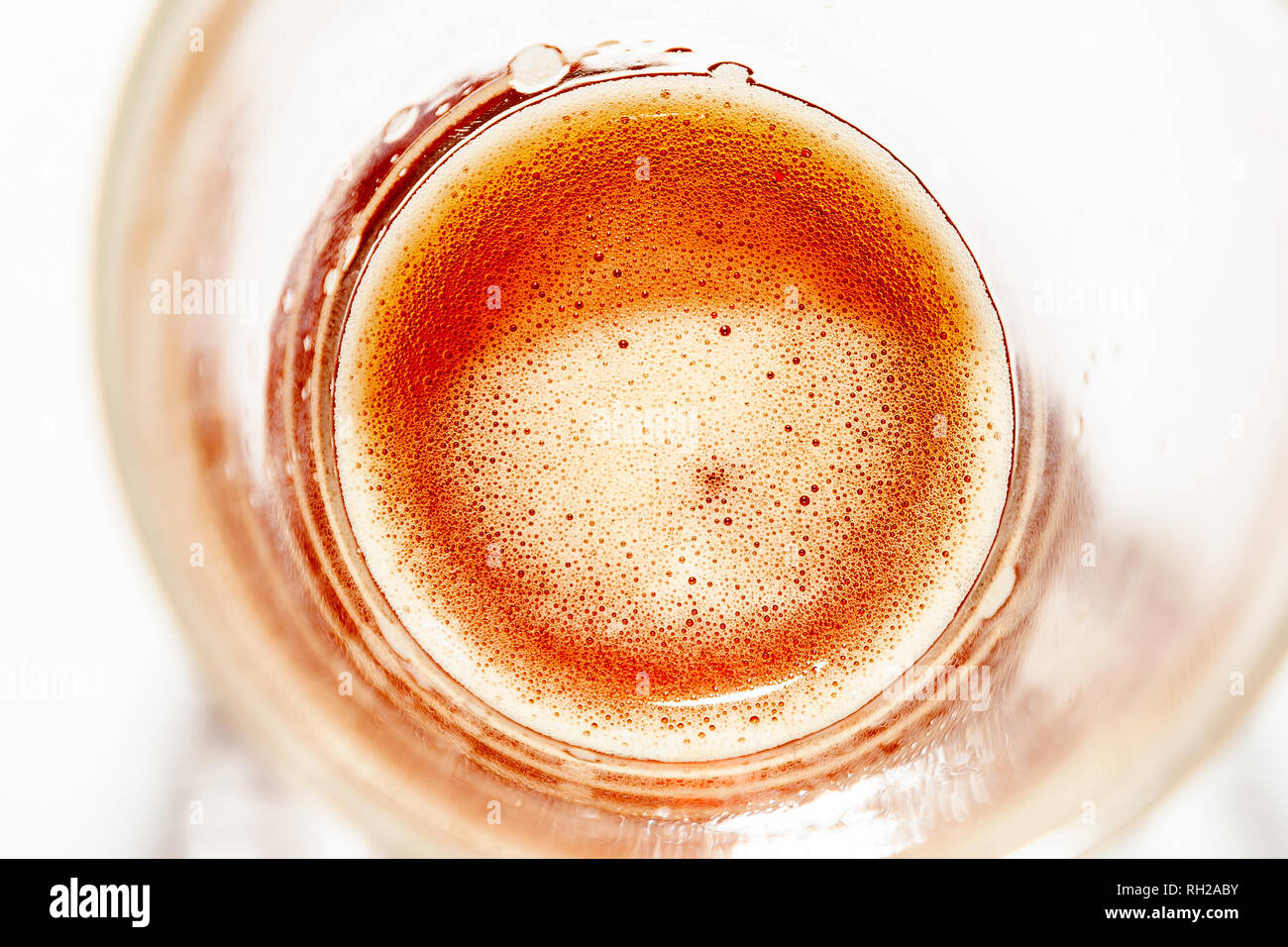 Wheat-colored alcoholic beer drink in a glass close-up with a slight froth on the surface suitable for summer parties refreshes perfectly. Stock Photo