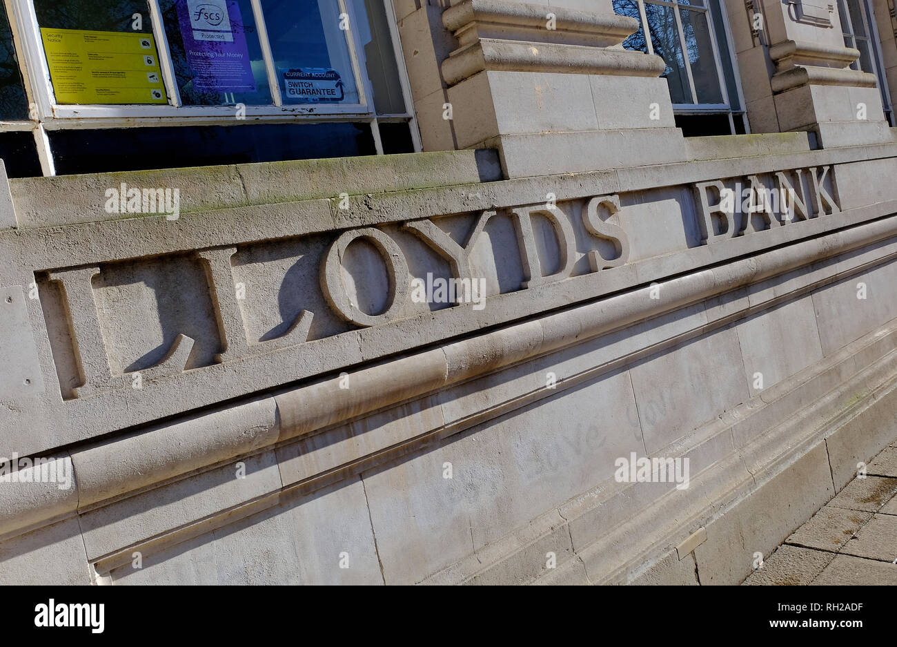 Lloyds bank carved in stone wall outside branch, norwich, norfolk, england Stock Photo