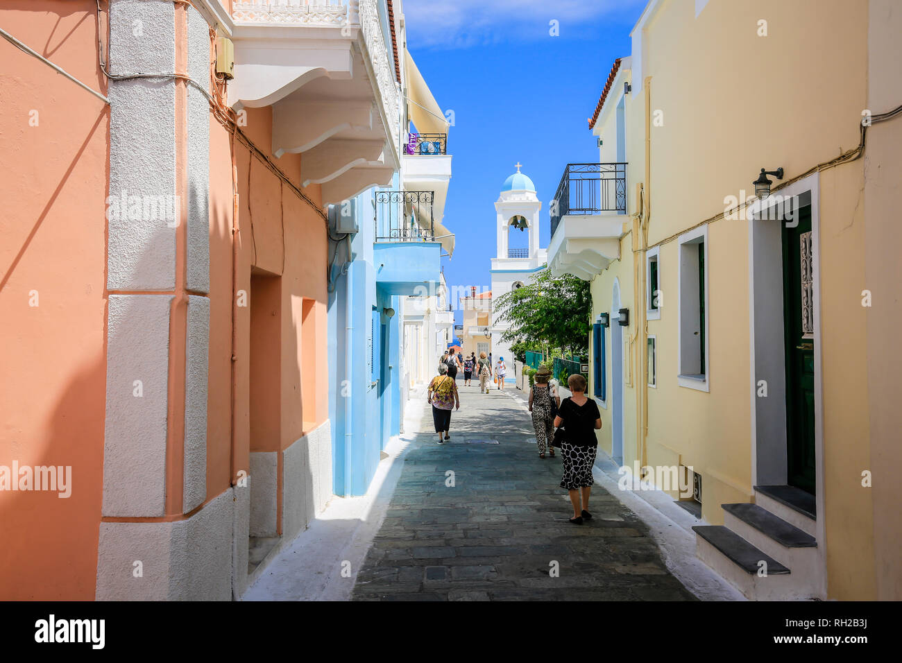 Andros City, Andros Island, Cyclades, Greece - Locals and tourists walk through the narrow, colorful streets of the old town of the capital Andros (Ch Stock Photo
