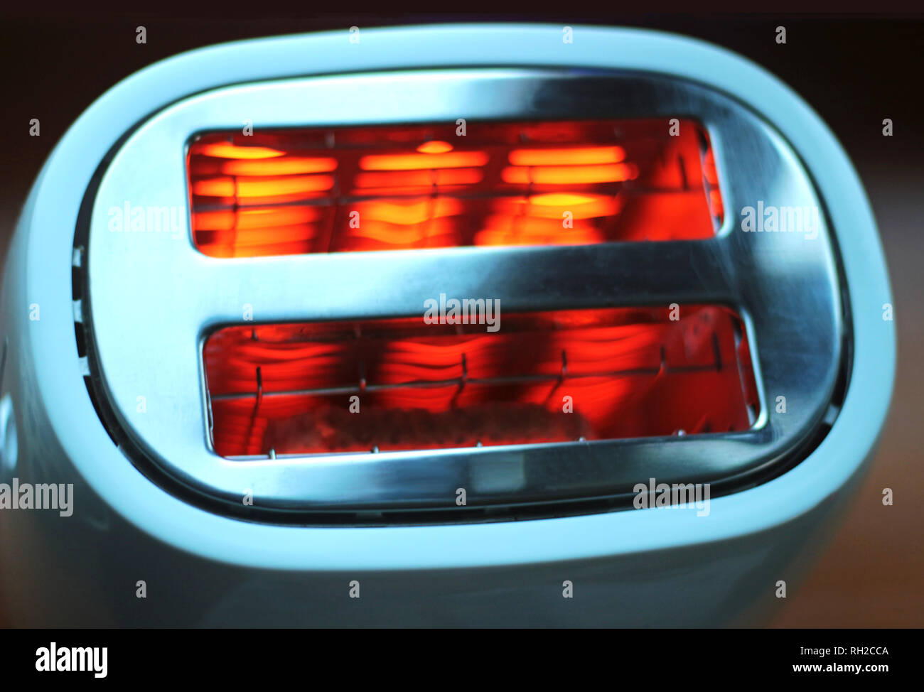 top view of a white toaster with red glowing heat elements Stock Photo