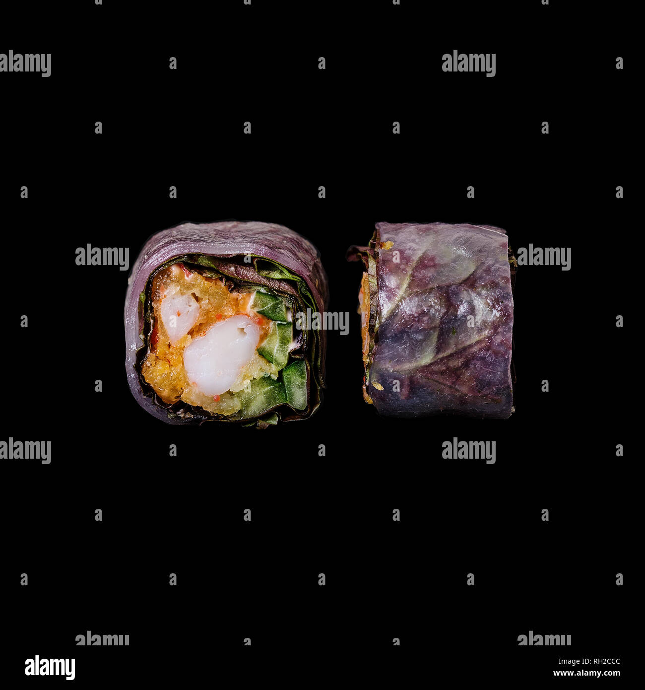https://c8.alamy.com/comp/RH2CCC/sushi-roll-in-rice-paper-with-crispy-shrimp-tempura-cucumber-and-lola-ross-isolated-in-black-background-RH2CCC.jpg
