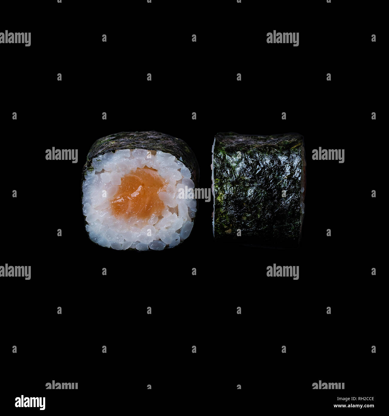 Sushi. Roll with salmon in nori leaf, isolated in black background Stock Photo