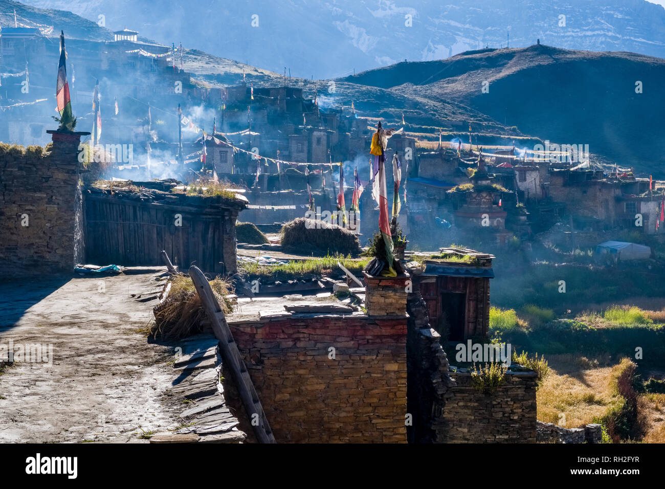 View on the traditional stone houses of the village in the morning, smoke covering the roofs Stock Photo