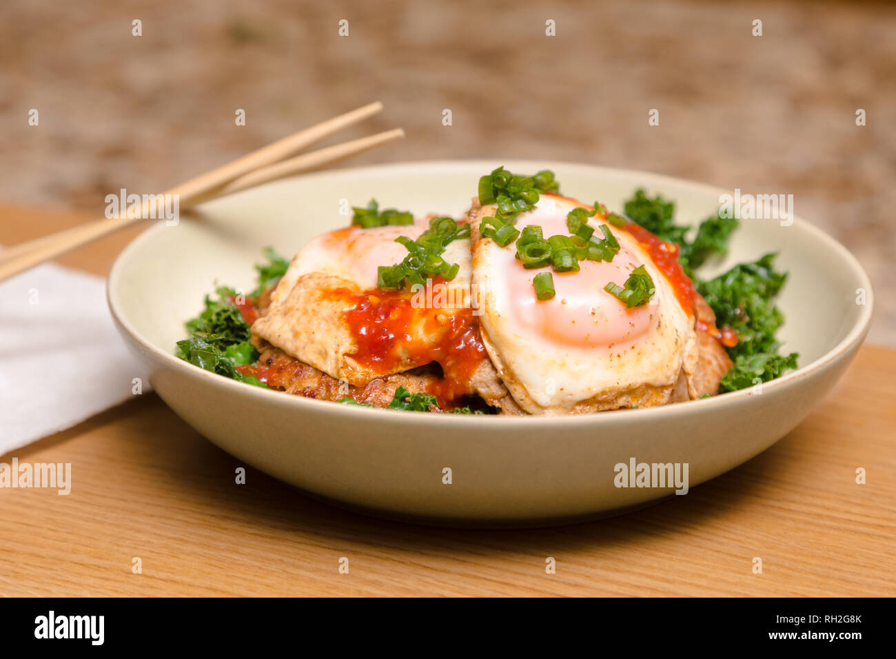 A ketogenic meal consisting of pork and kale stir fry with fried egg on