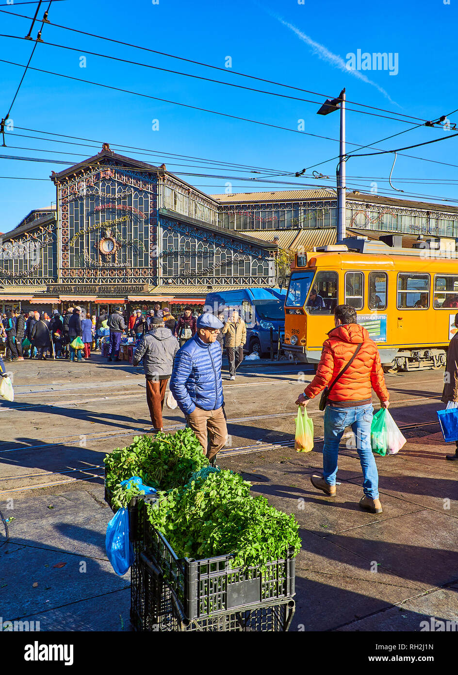 Citizens in front of the Antica Tettoia dell'Orologio building, the Fresh food part of Porta Palazzo market. Turin, Piedmont, Italy. Stock Photo