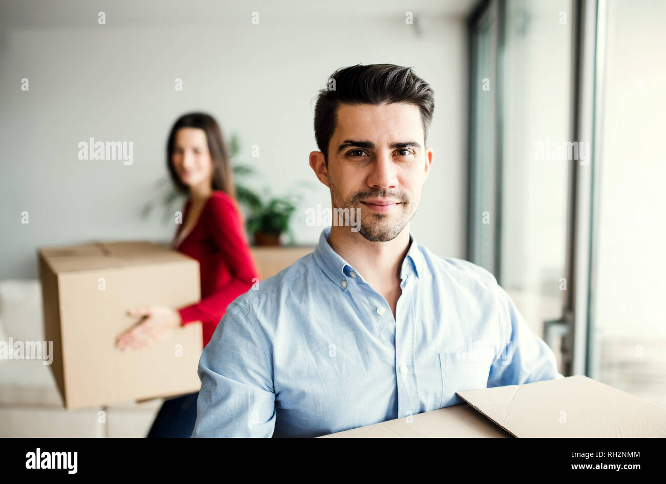 Young happy couple with cardboard boxes moving in a new home Stock ...