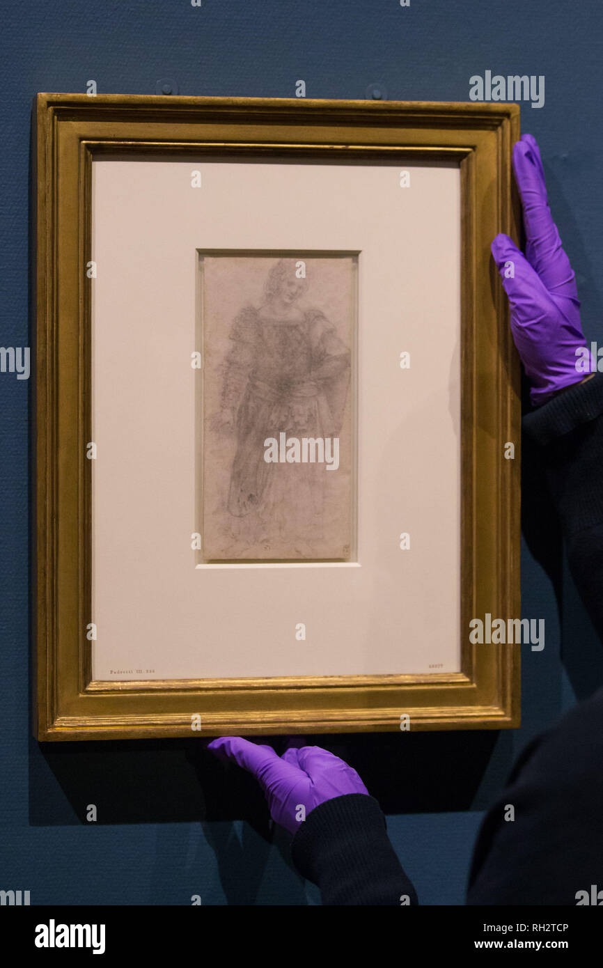 A gallery assistant adjusts 'A standing masquerader c.1517-18' as 12 drawings by Leonardo da Vinci go on display at Birmingham Museum & Art Gallery ahead of the opening of an exhibition to mark the 500th anniversary of the Renaissance master's death. Stock Photo