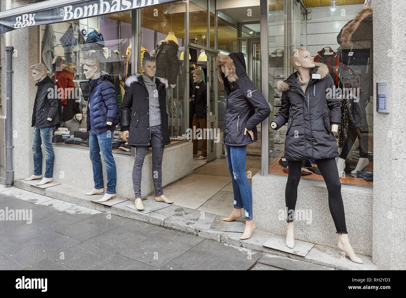 Display mannequins outside the storefront in a clothing store on a