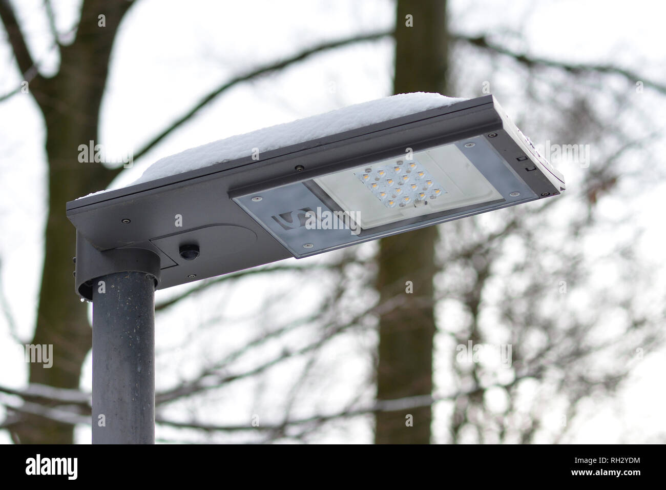 Close up of a solar powered environment friendly LED street light during cloudy weather Stock Photo