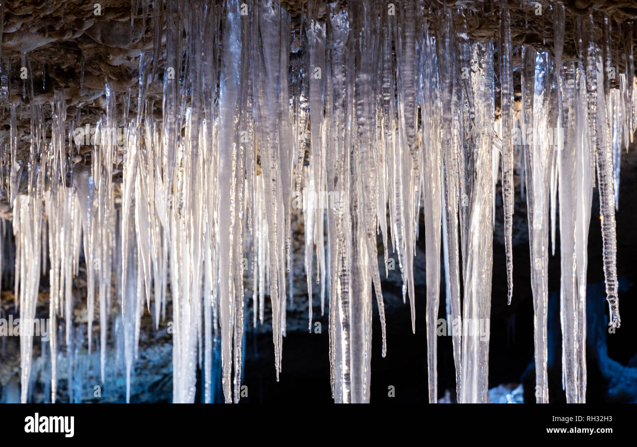 Many Icicles Hanging From The Ceiling Of The Cave Stock