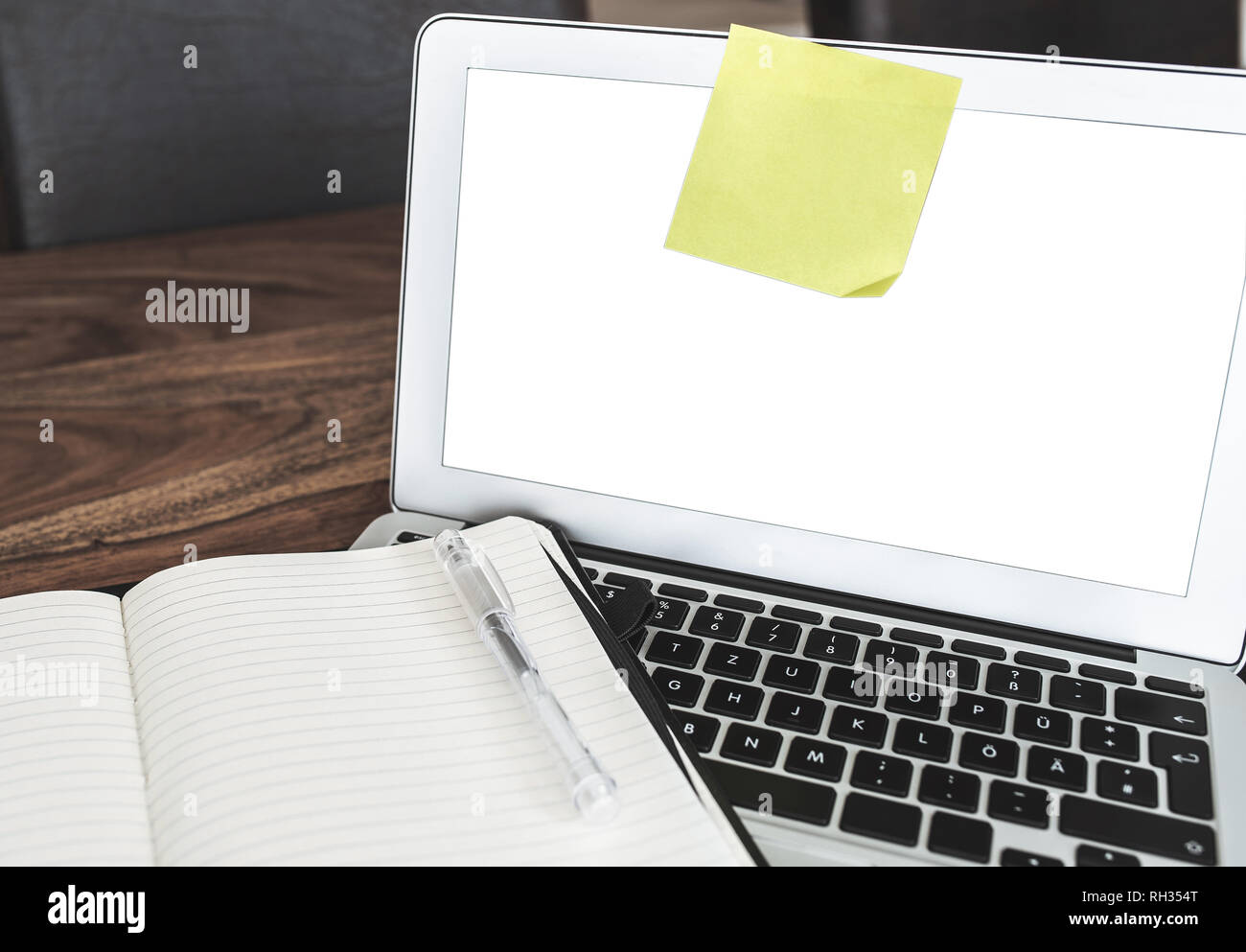 blank yellow adhesive note on laptop screen Stock Photo