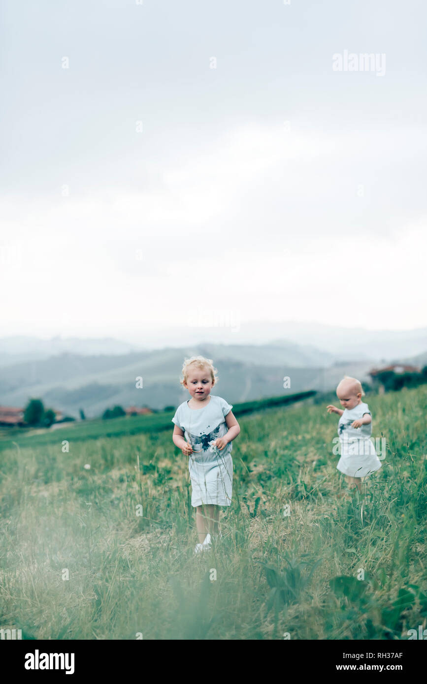 Two girls walking away hi-res stock photography and images - Alamy