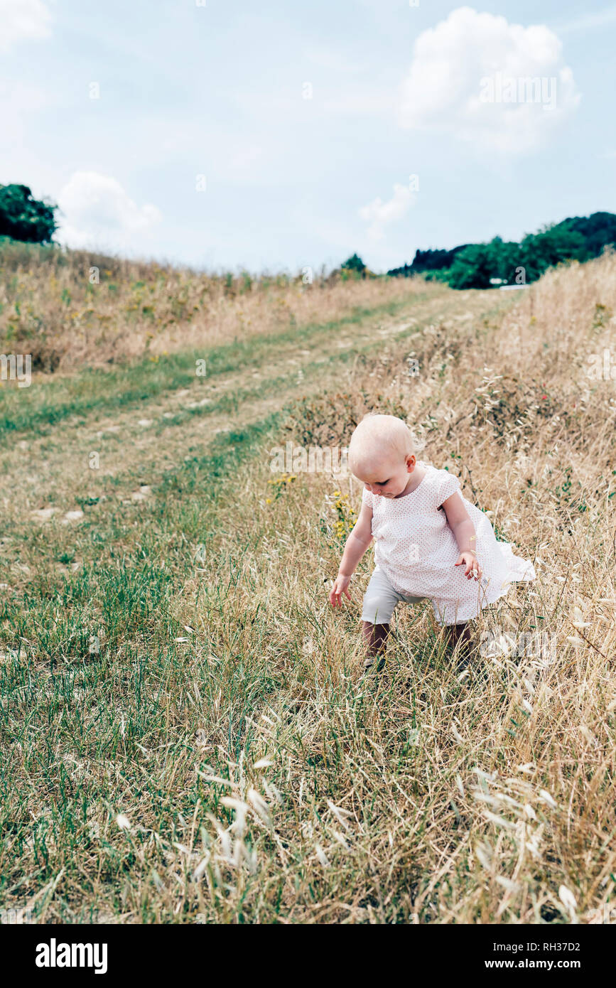 Girl walking on meadow Stock Photo Alamy