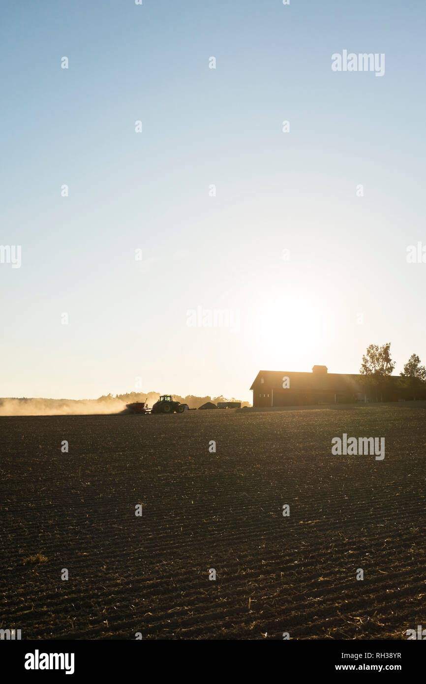 Tractor on field Stock Photo - Alamy