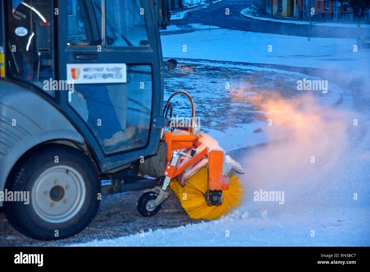 City snow plough cleaning snow on city street. City snow plow truck
