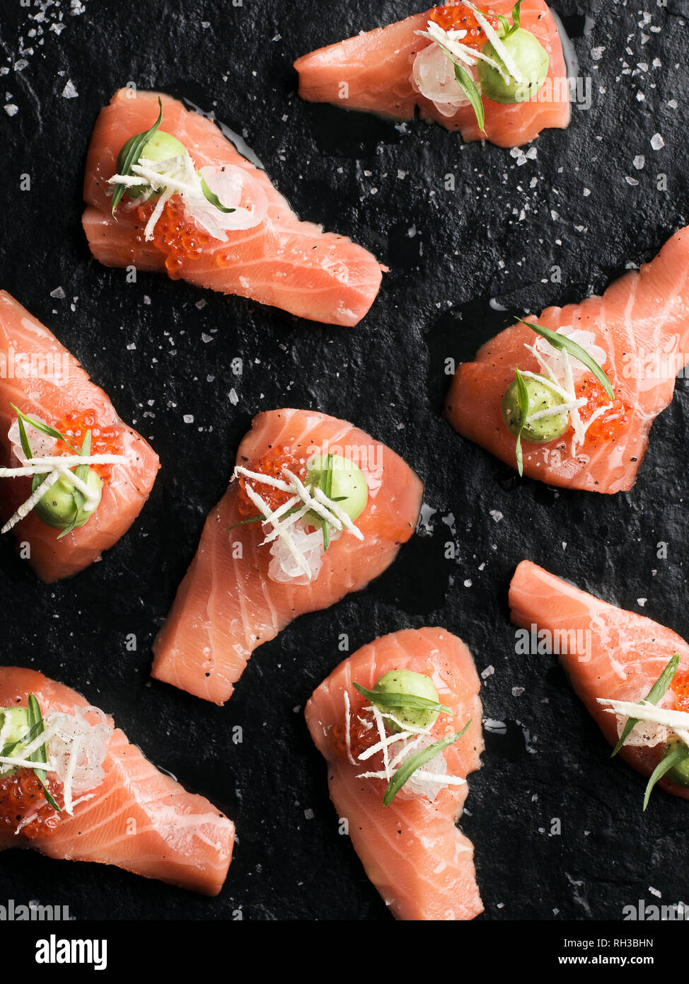Salmon on black background Stock Photo - Alamy