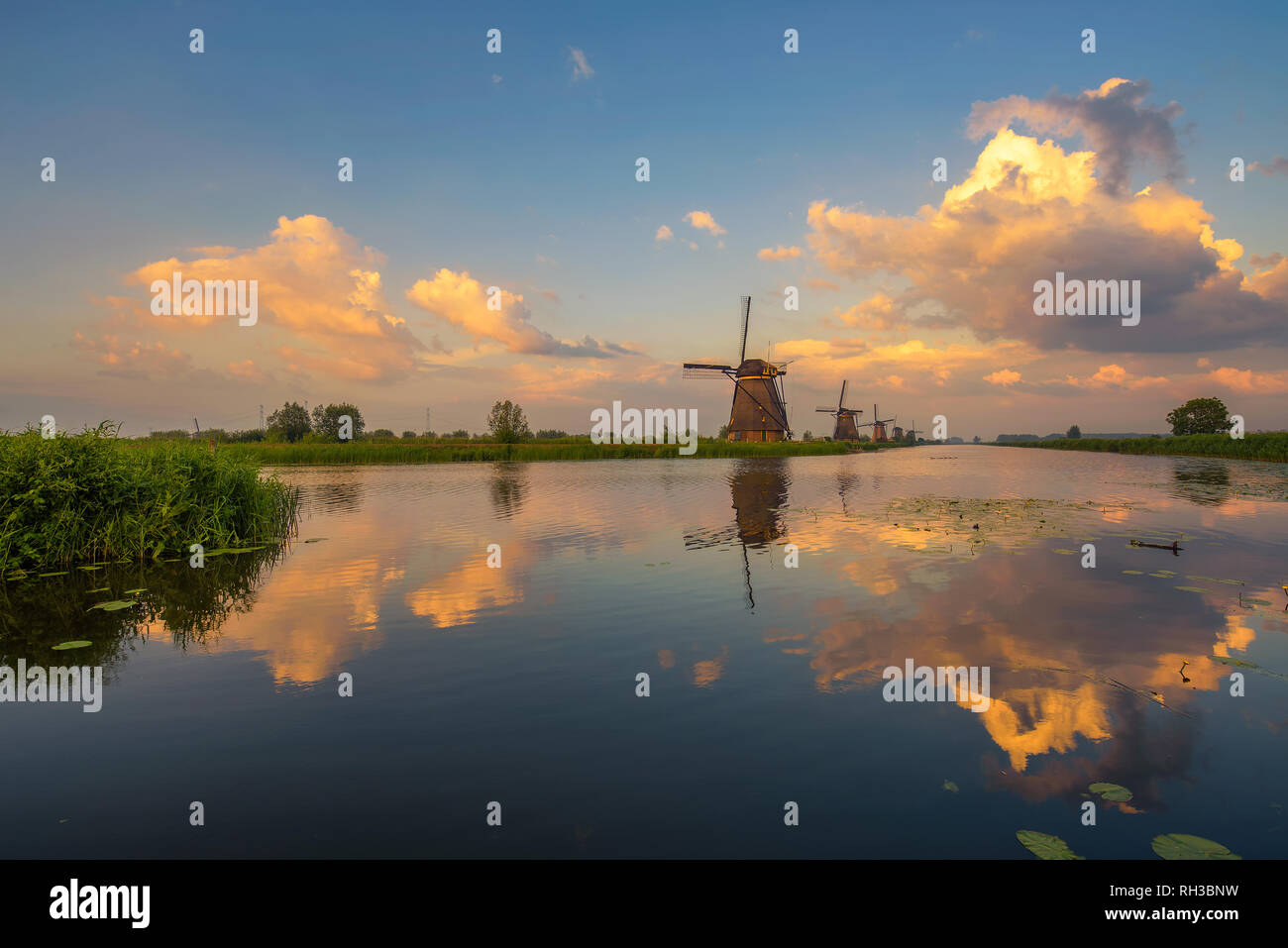 Sunset above old dutch windmills in Kinderdijk, Netherlands Stock Photo