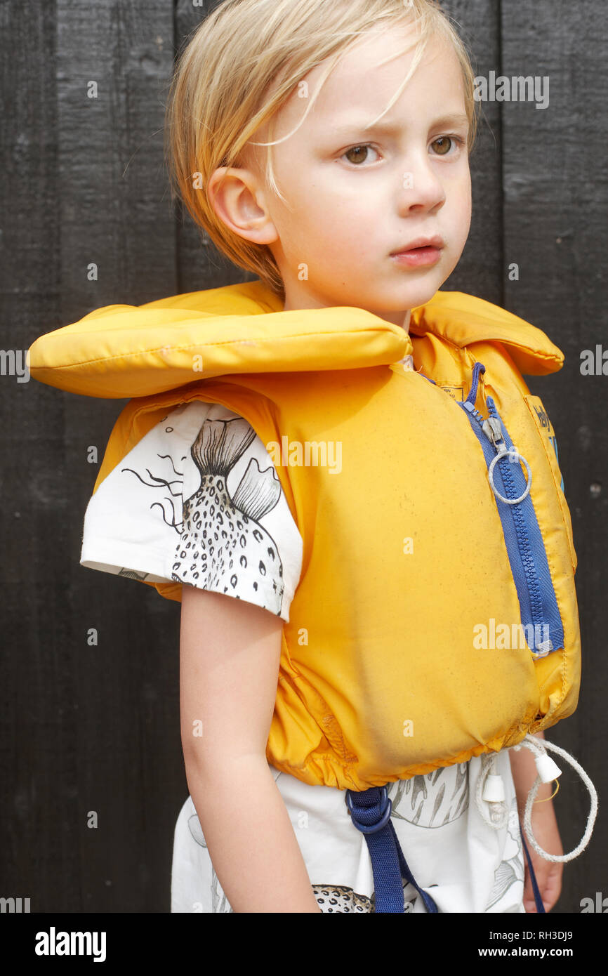 Boy wearing yellow life belt Stock Photo
