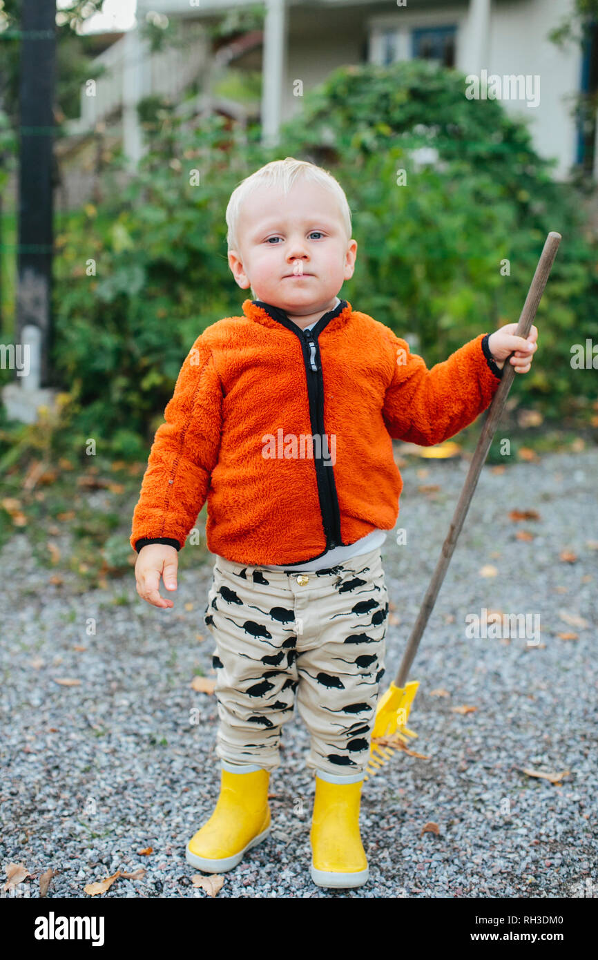 Boy with rake Stock Photo - Alamy