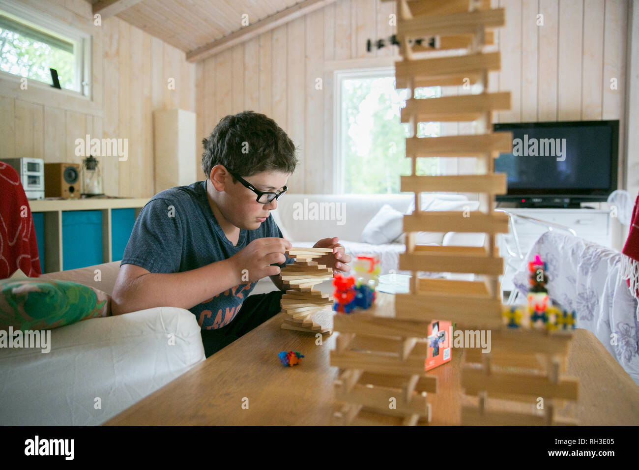 Boy playing with wooden blocks Stock Photo