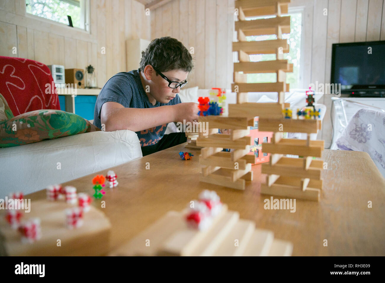 Boy playing with wooden blocks Stock Photo