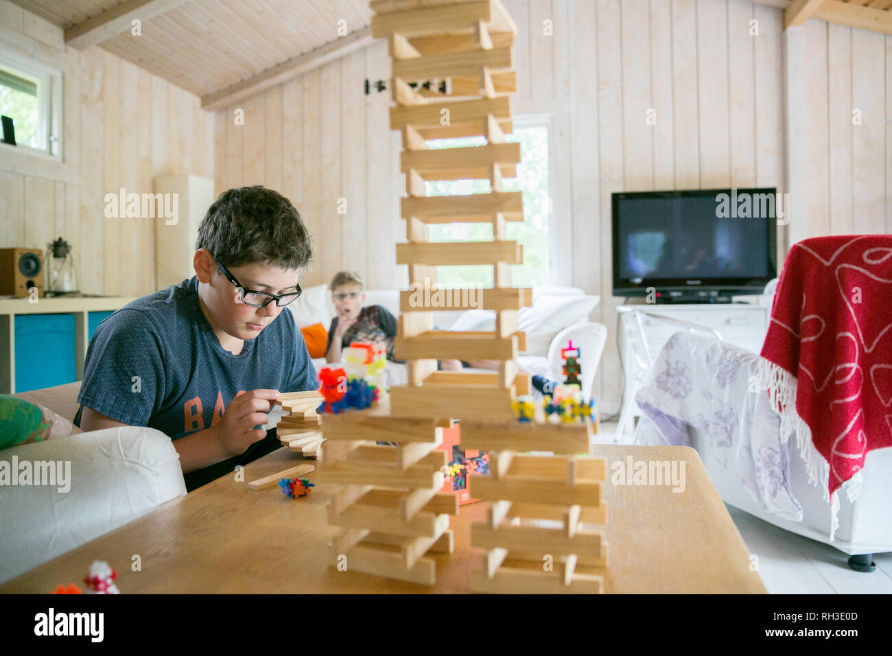 Boy playing with wooden blocks Stock Photo - Alamy