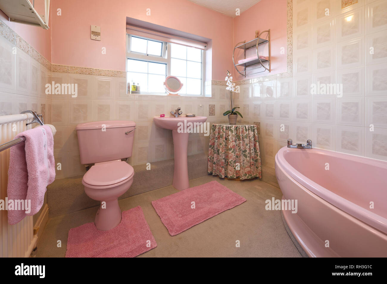 An old fashioned pale pink coloured bathroom suite Stock Photo Alamy
