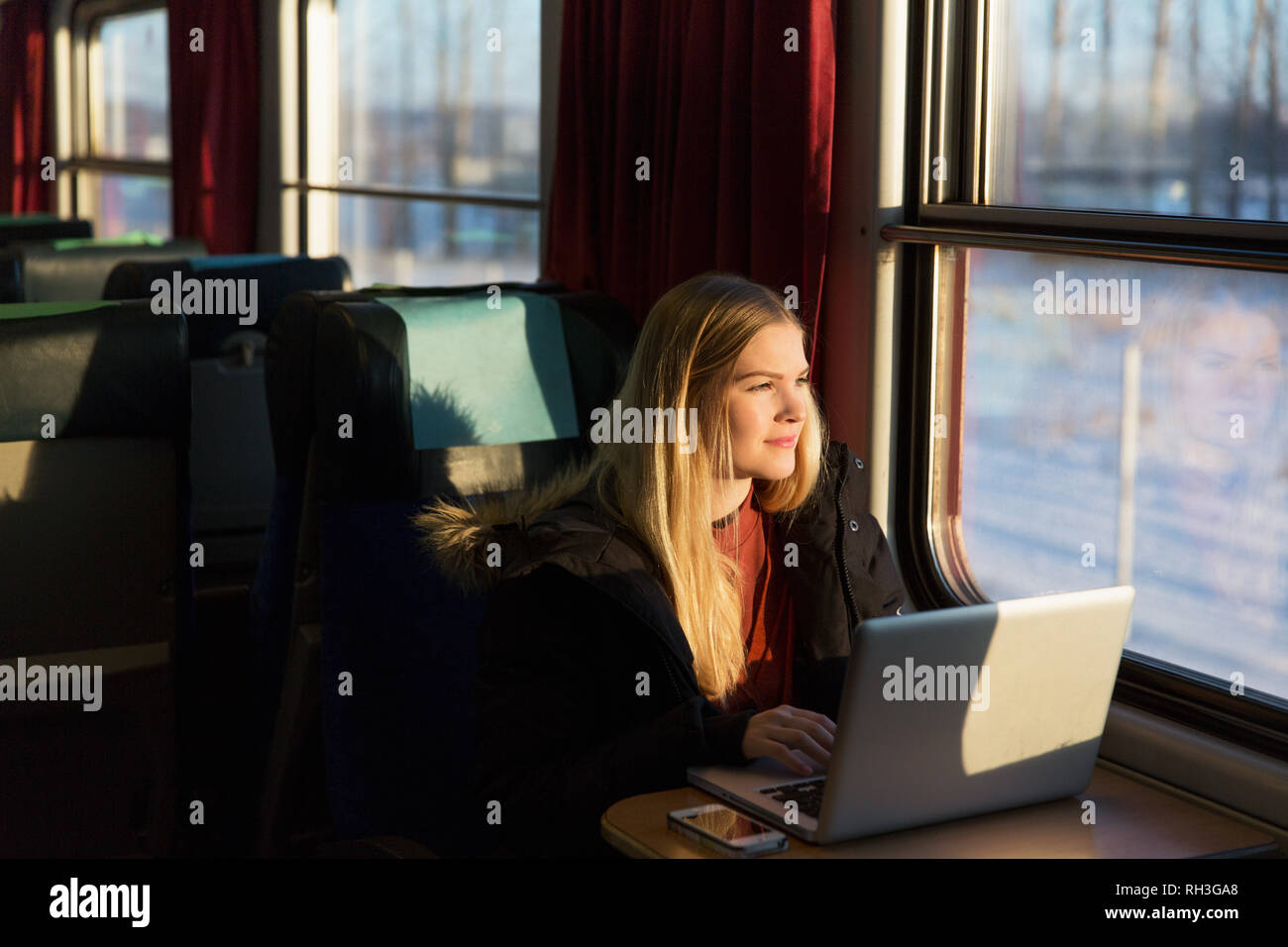 Young woman with laptop in train Stock Photo Alamy