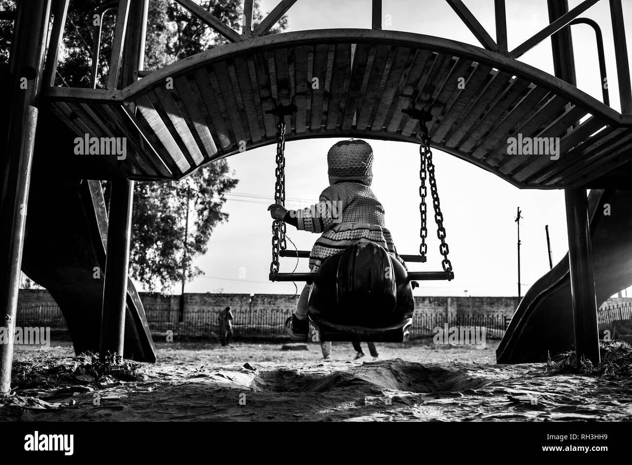 SWING LITTLE GIRL, SWING TO THE SKY. BECAUSE SKY IS THE ONLY LIMIT. Stock Photo