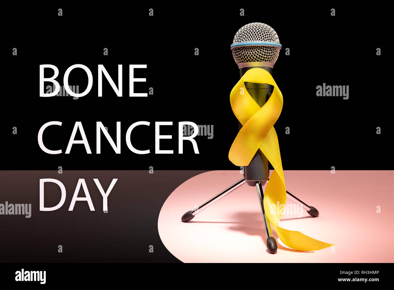 Yellow ribbon symbolic color for Sarcoma Bone cancer awareness and suicide prevention with microphone. The cancer, health, help, care, support, hope, illness, healthcare concept Stock Photo