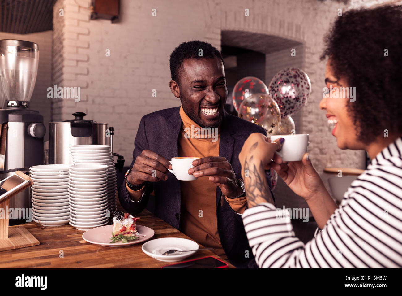 Happy Positive Nice Couple Having Coffee Together Stock Photo Alamy Happy Positive Nice Couple Having Coffee Together Stock Photo Alamy