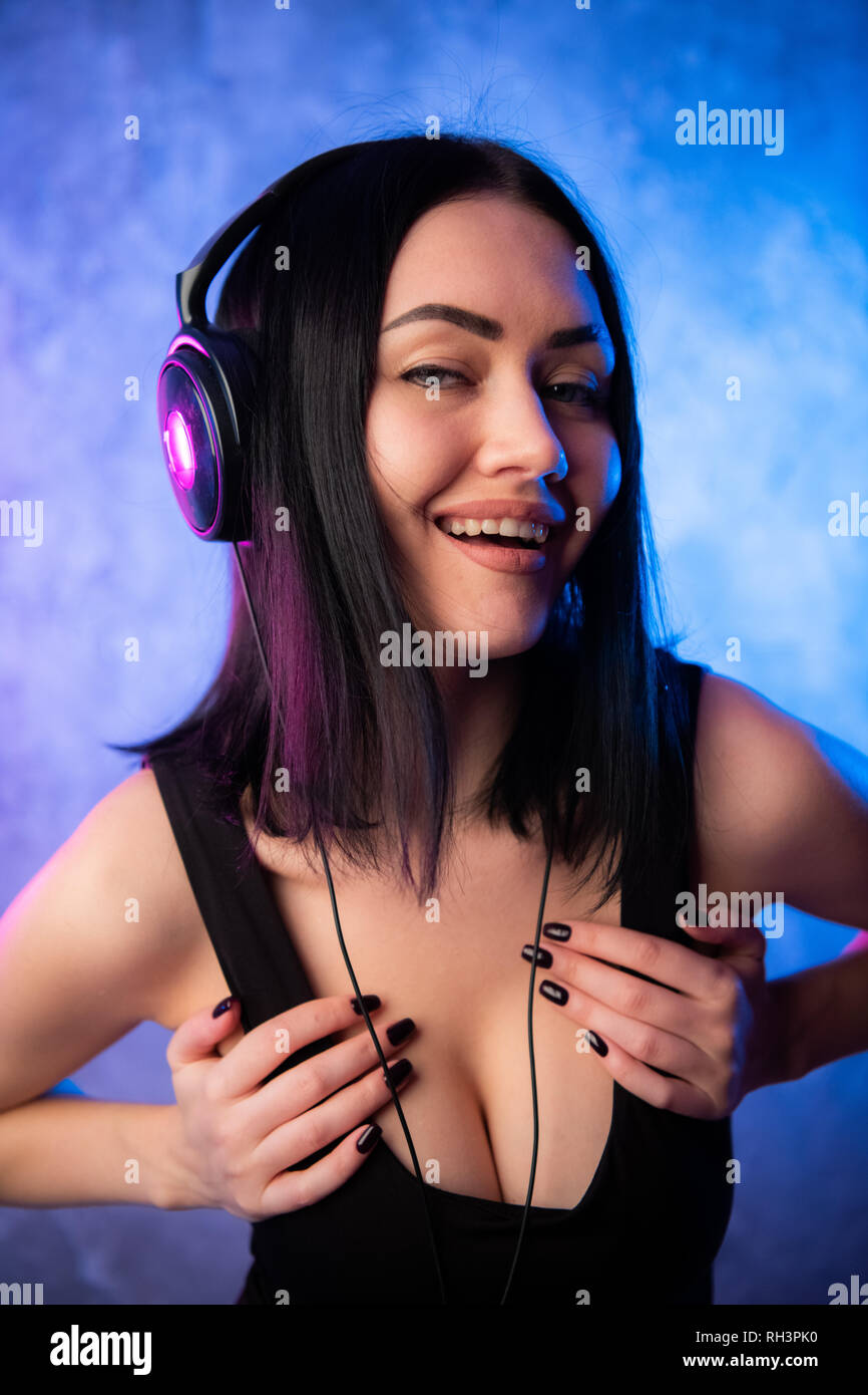 Sexy young girl DJ wearing headphones close portrait Stock Photo - Alamy