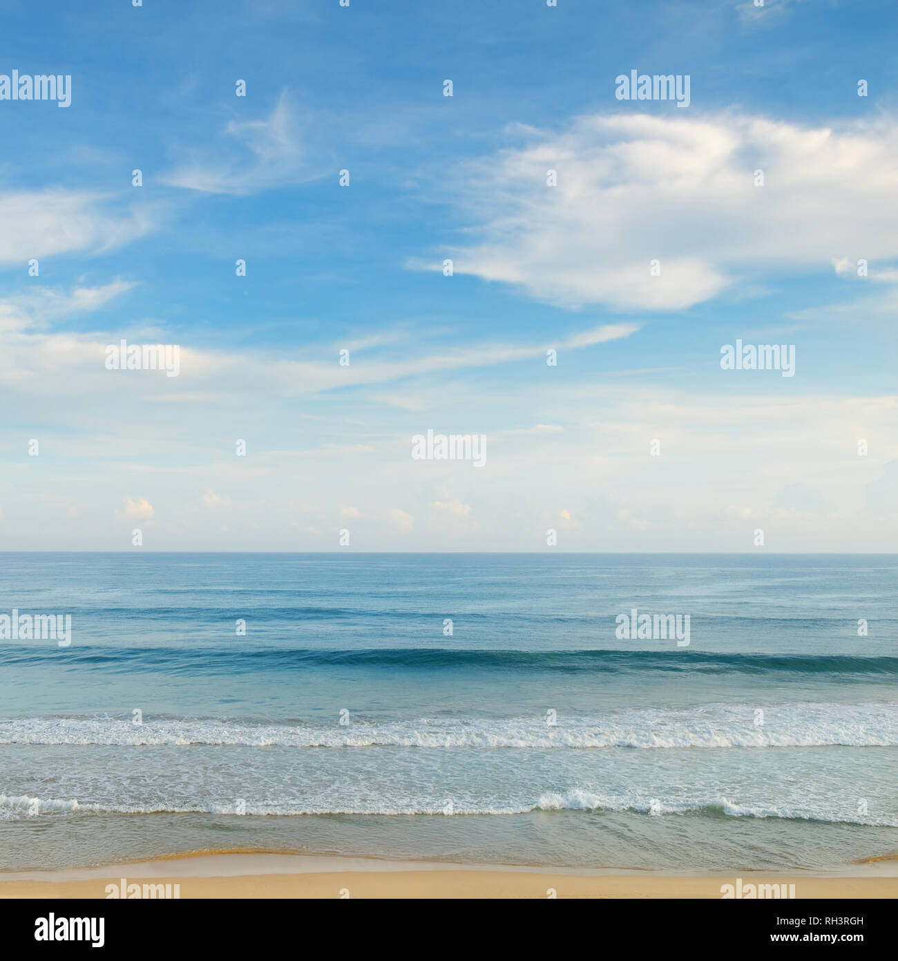 ocean, sandy beach and blue sky Stock Photo - Alamy