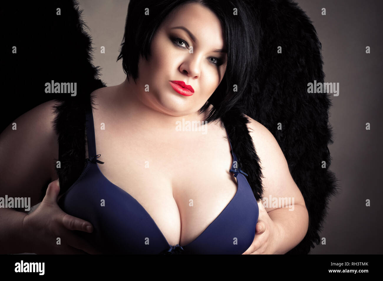 sexy fat woman with big breasts in bra with black wings Stock Photo - Alamy