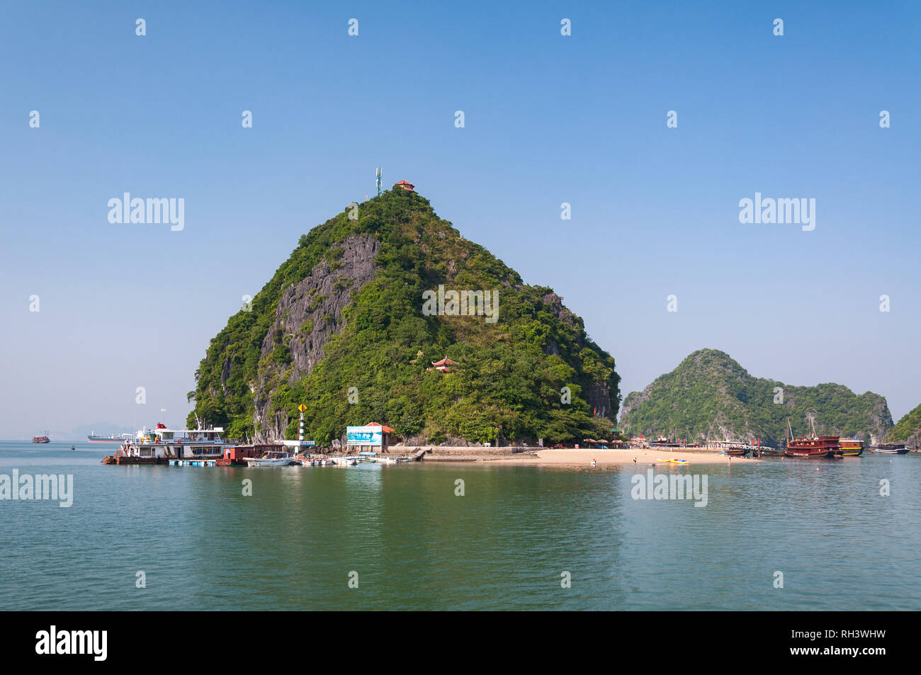 Ti Top beach or Bai bien Ti Top with wooden junk boats anchored off shore on a sunny afternoon, Halong or Ha Long Bay, Vietnam Stock Photo