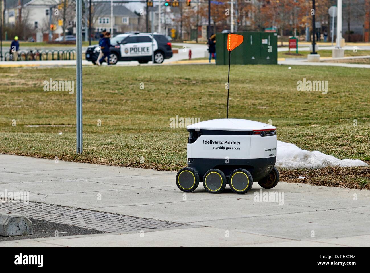 Fairfax, Virginia, USA - January 29, 2019: An autonomous food delivery robot travels enroute to a customer on George Mason University's main campus. Stock Photo