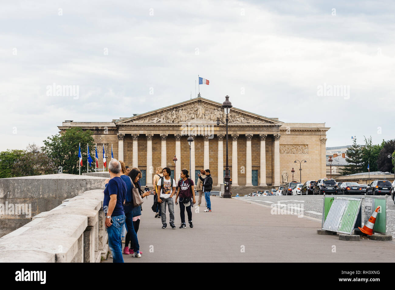 PARIS, FRANCE - MAY 21, 2016: Pedestrians on Pont de la Concorde with Assemblee Nationale The National Assembly in the background in central Paris Stock Photo