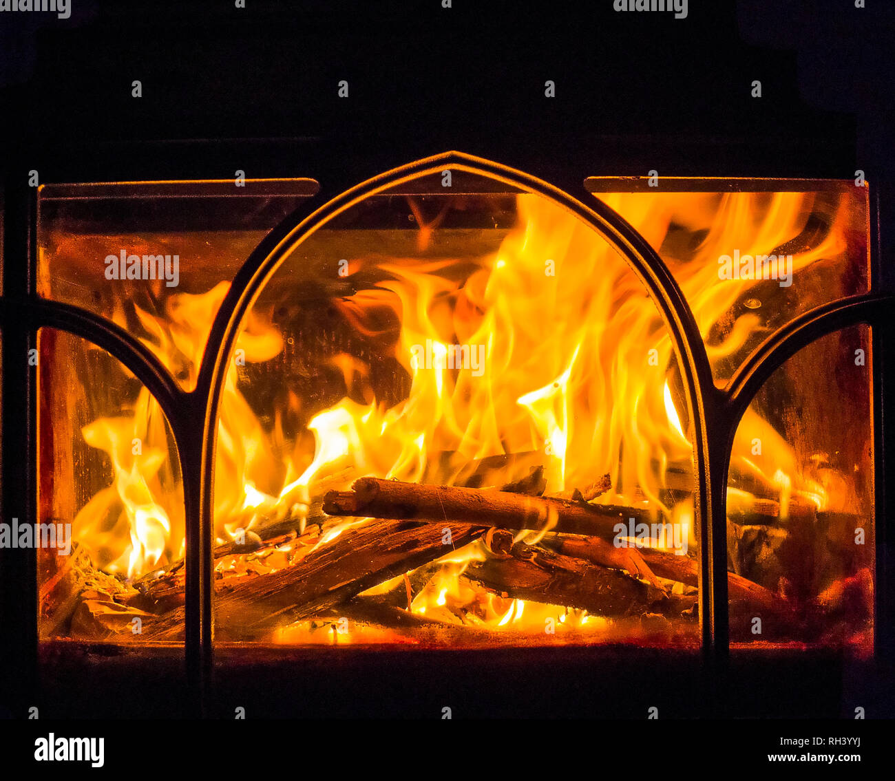 Roaring flames from a fire burning in a woodburning stove in winter