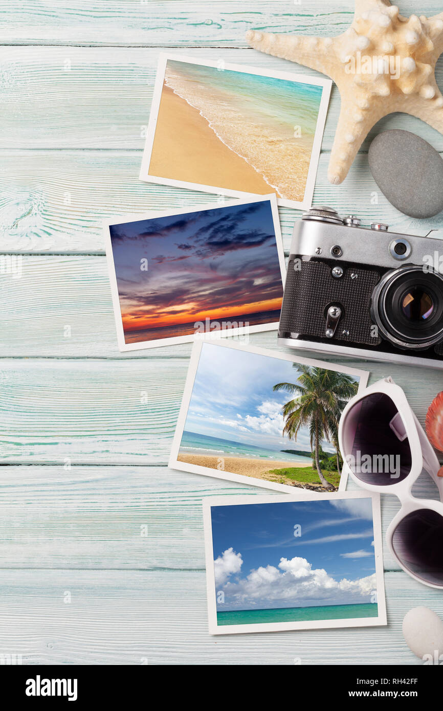 Travel vacation concept with sunglasses, camera and weekend photos on wooden backdrop. Top view with copy space. Flat lay. All photos taken by me Stock Photo