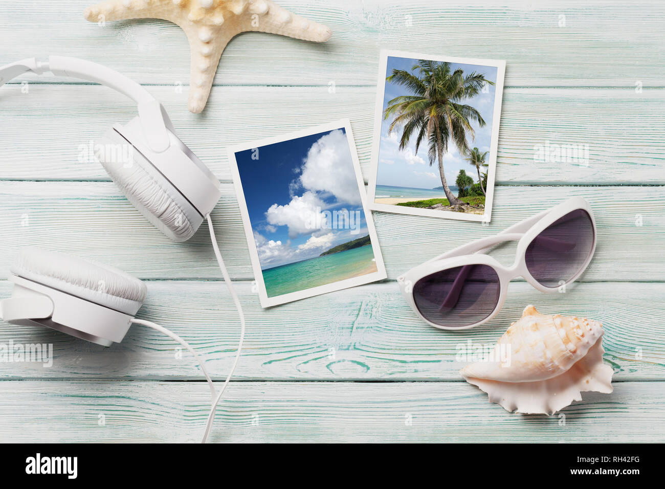 Travel vacation background concept with sunglasses, headphones and weekend photos on wooden backdrop. Top view. Flat lay. All photos taken by me Stock Photo