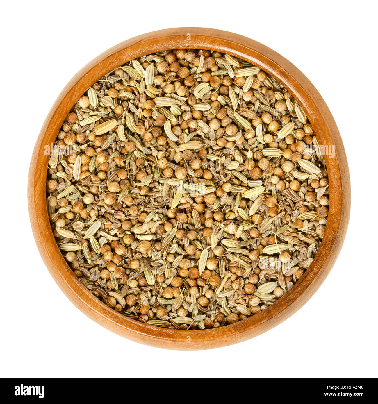 German bread spice mixture in wooden bowl. Mix of anise, fennel, coriander and caraway seeds. Used as digestive aid in bread recipes. Stock Photo
