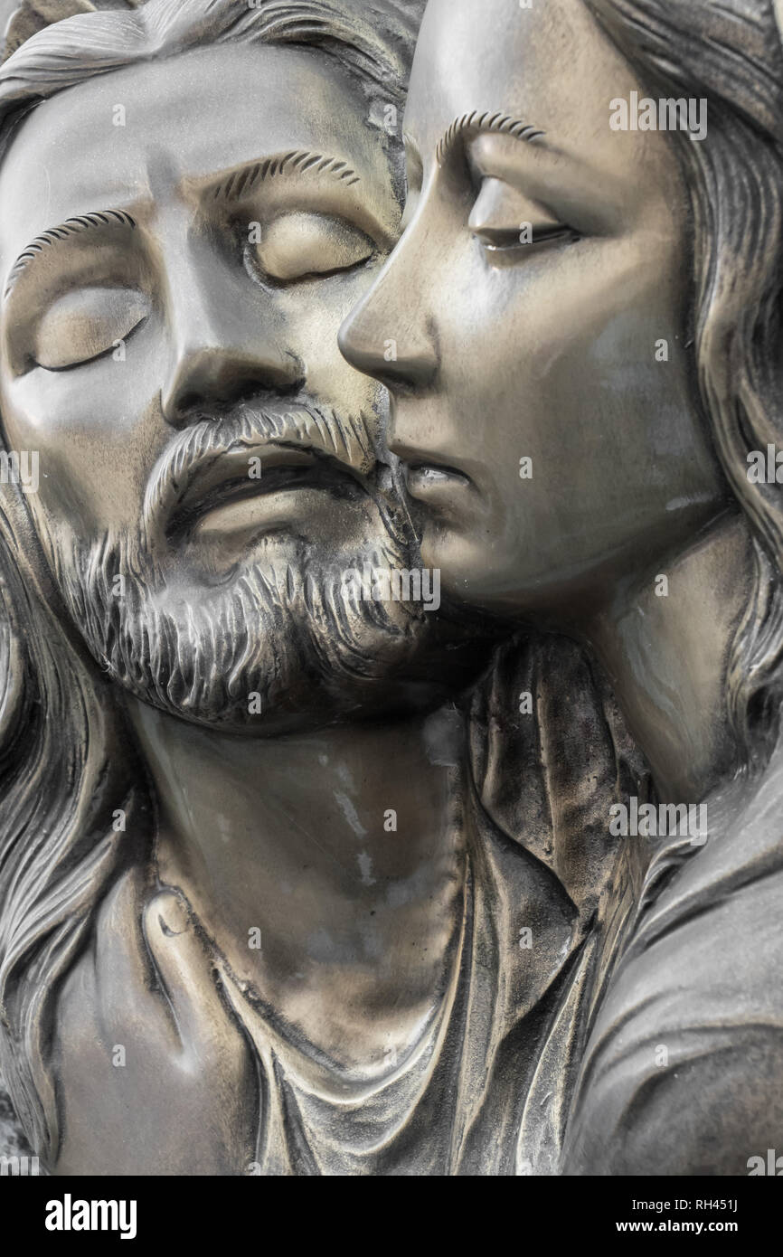 Bas-relief in bronze representing The Pity of Michelangelo. Faces of Holy Mary mother and Jesus Christ after the Crucifixion. Stock Photo
